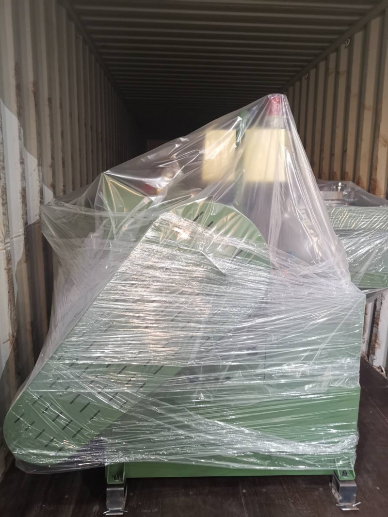 A KONFU thread rolling machine being loaded into a shipping container for international delivery.