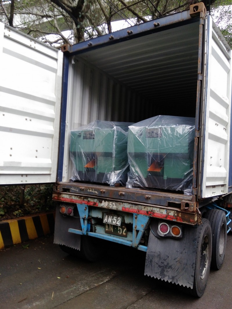 The HH-1538 cold forming machines being carefully loaded into a shipping container for international delivery.